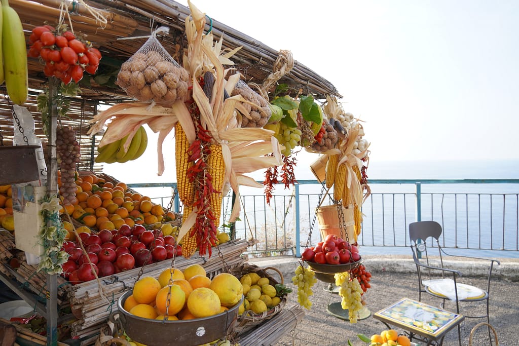 A fruit stand sits along the water-front on the Amalfi Coast.