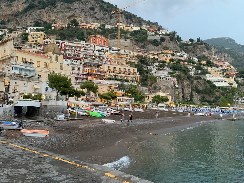 Positano, Italy from the ferry dock. You can see the beach and the cliffside houses.